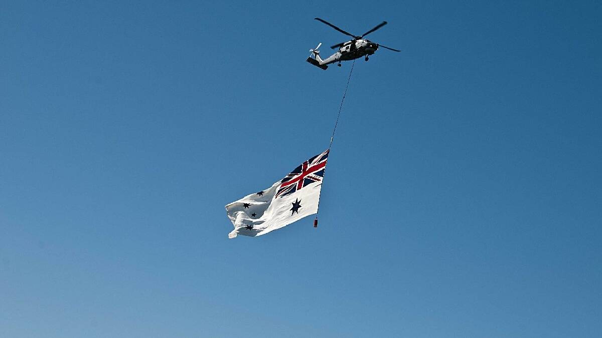 SYDNEY: Royal Australian Navy pilot Lt. Alistair Auld flew the Australian White Ensign (AWE) under his   Seahawk at the International Fleet Review.  