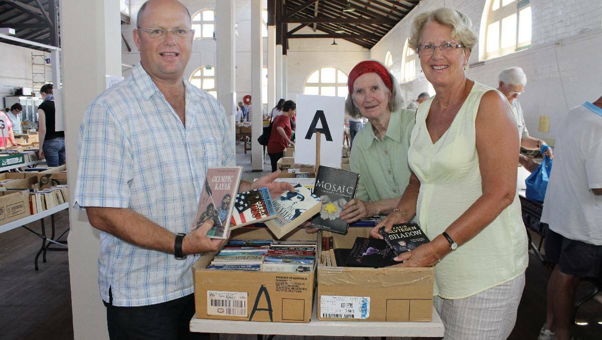 BEGA: Setting up for the 2013 January Rotary Book Fair are (from left) club members Jeff Tipping, Anna Senior and Jan Southcott. Rotary is hoping its 2014 fair matches the success of last year.